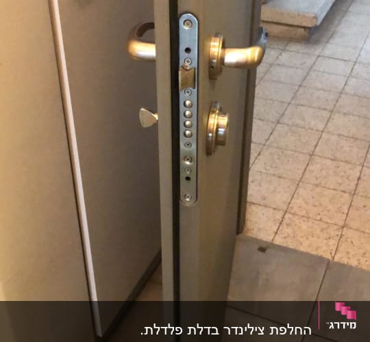 דלת פתוחה עם מנעול ומנגנון נעילה